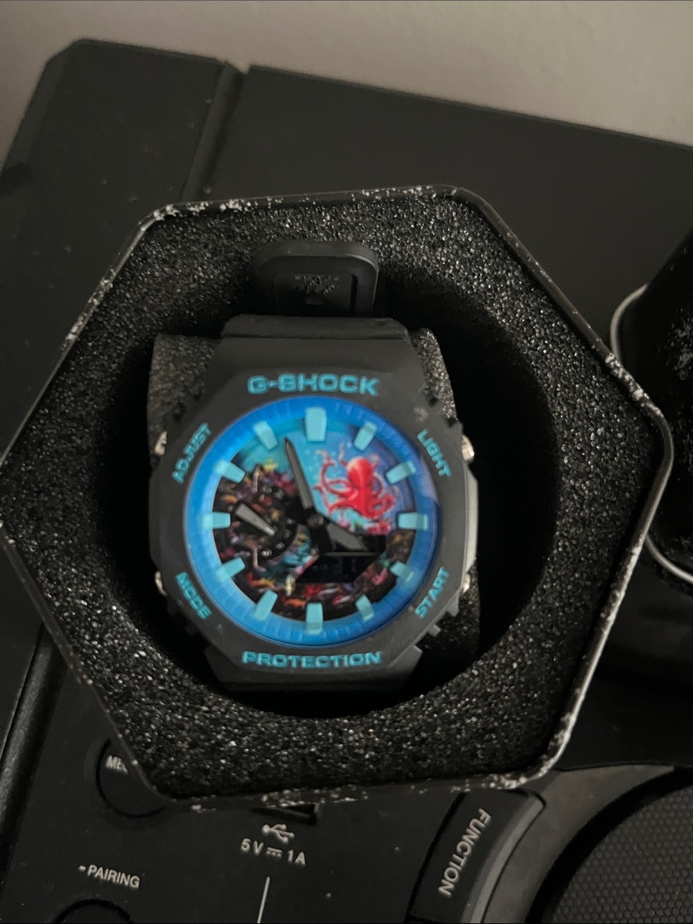 G-Shock Black Watch with Bright Blue Bezel and Multicolor Dial